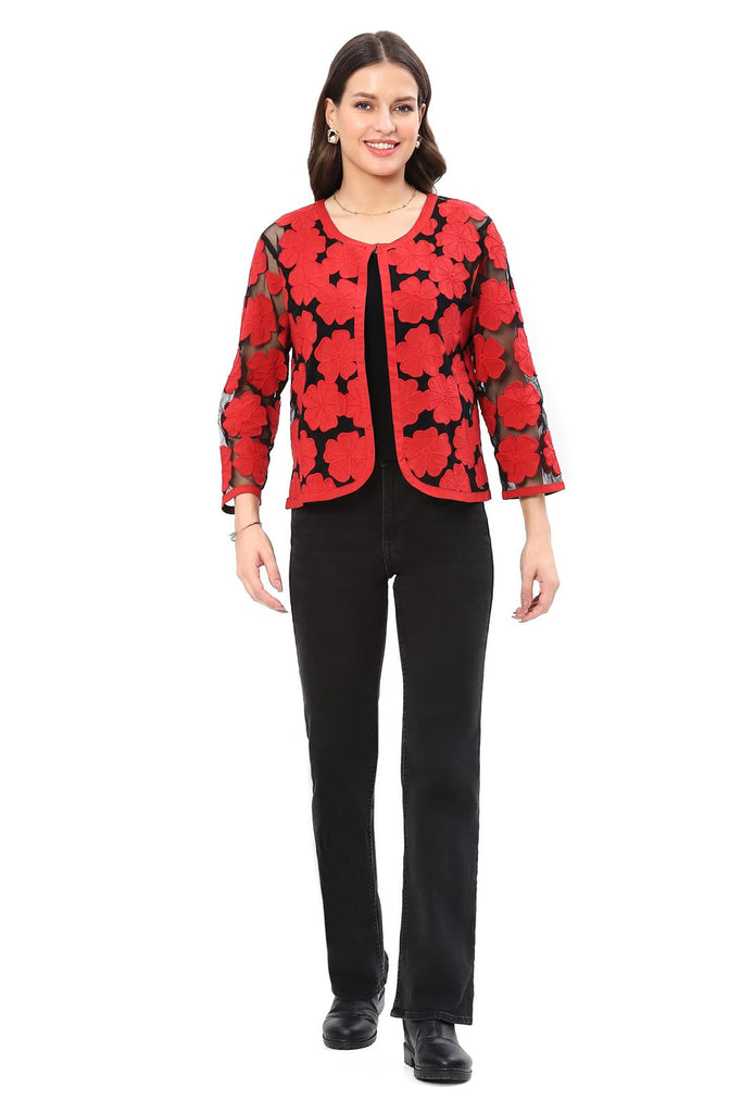 Woman wearing a red floral patterned jacket on a white background