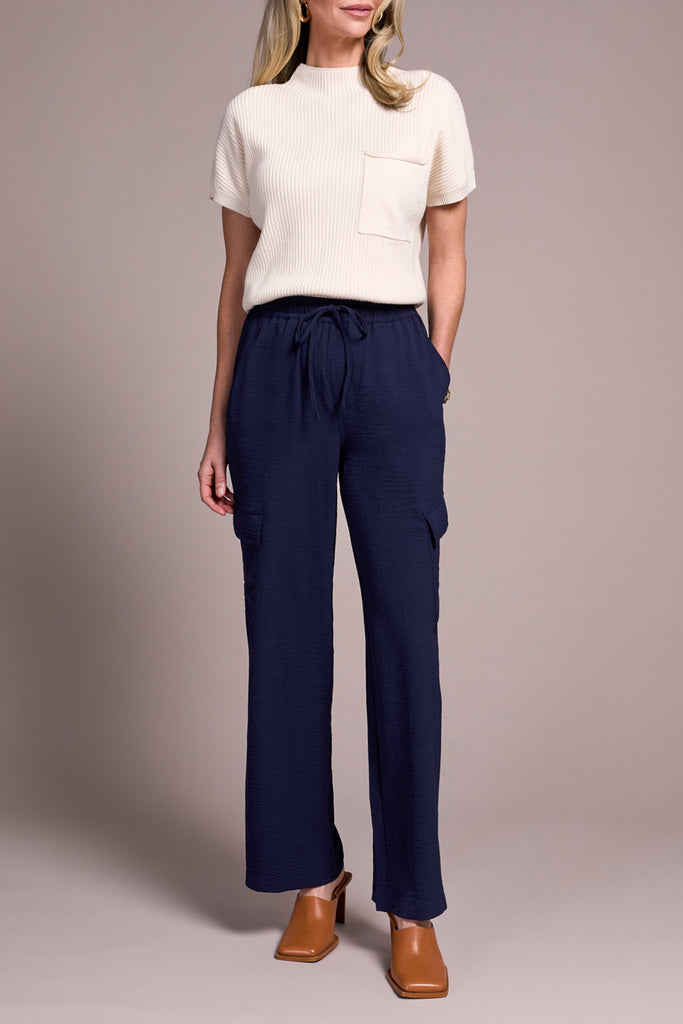 This image features the Nightfall Flowy Cargo Pant, a stylish and comfortable pair of trousers suited for evening wear. The pants are navy blue with a subtle texture, offering a sleek and sophisticated look.