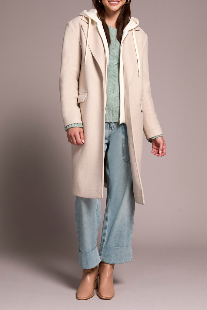 This image features a stylish oatmeal-colored trench coat with a hoodie, perfect for both fashion and functionality. The coat is designed with a classic and elegant style, featuring a full-length cut that provides a versatile fit for various body types.