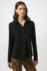 Woman wearing a black shirt with white buttons and leopard print pants on a white background