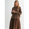 Woman wearing a brown outfit on a white background