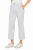 A pair of cropped, wide leg indigo stripe crop pants with front and back pockets, worn by a model with hands in pockets, paired with white sneakers.