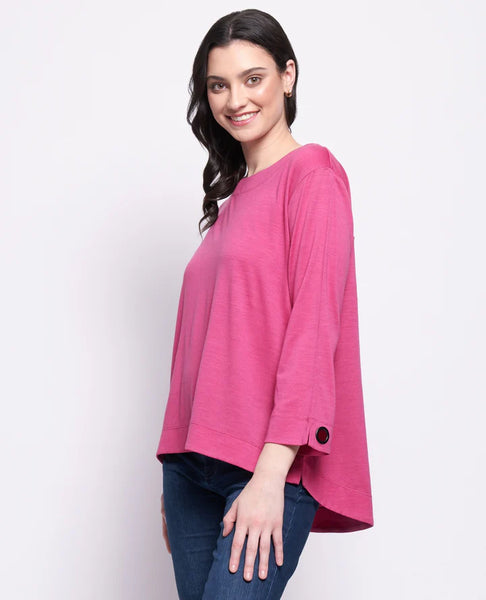 Woman wearing a pink top and blue jeans on a white background