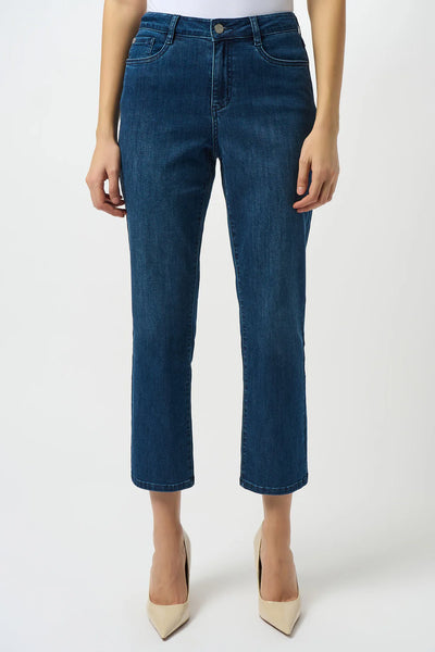 Blue jeans worn by a person on a white background