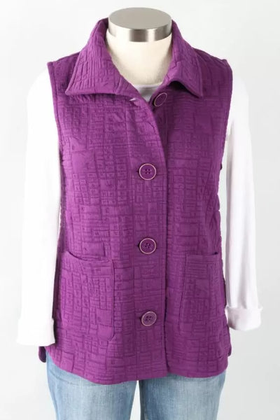 A purple box quilt vest with a collar, button closures, and no visible sleeves, displayed on a mannequin with a white shirt and blue jeans.