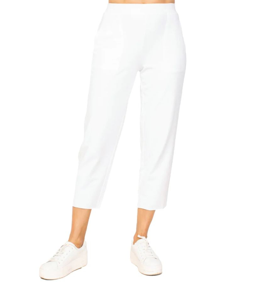 A pair of white French terry crop pants with elastic waistband, worn with white sneakers.