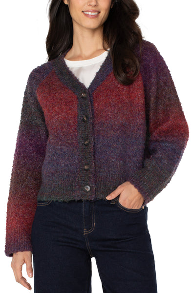 Woman wearing a multicolored cardigan with a white background