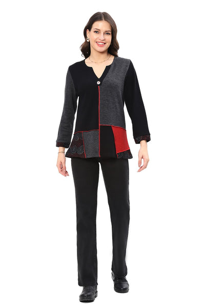 Woman wearing a black, gray, and red jacket on a white background