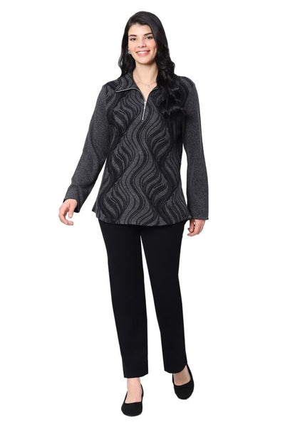 Woman wearing a black patterned top and black pants on a white background
