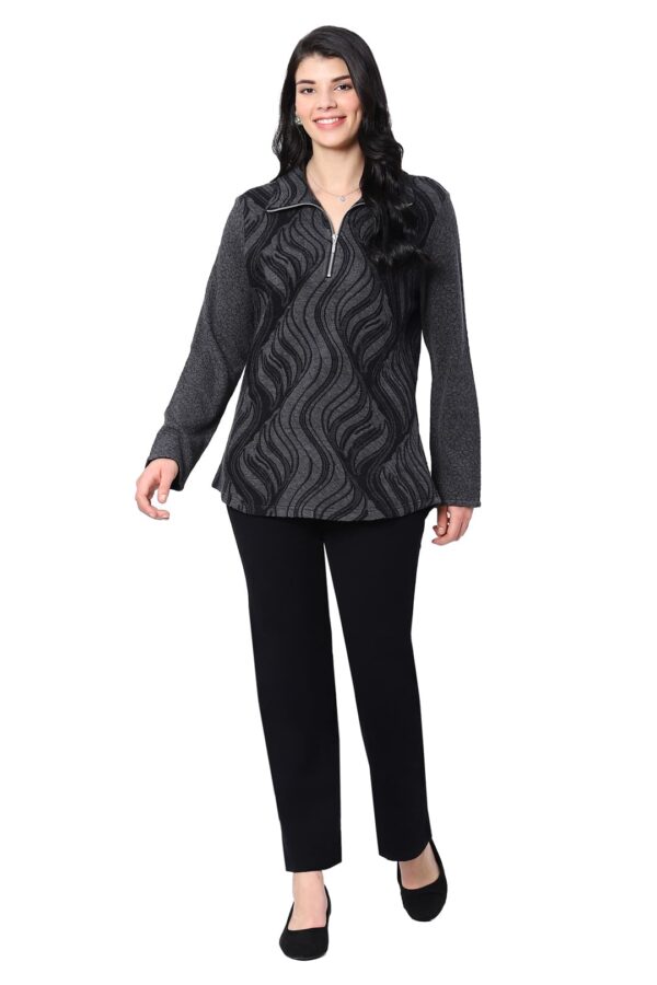 Woman wearing a black patterned top and black pants on a white background